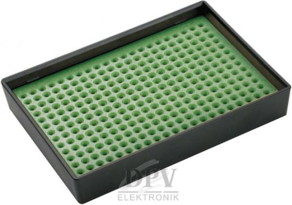 The image displays a rectangular, flat box with a green, dimpled surface. The dimples are evenly distributed and assist in securing objects. The box has a black border.