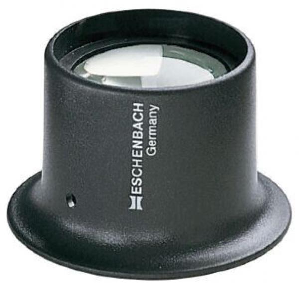 The image shows a black magnifying glass with a sturdy, round base. The lens is clear and convex, and on the base it says "ESCHENBACH Germany" in white lettering.