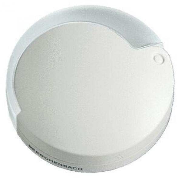 The image displays a round, flat object in soft, light colors. It has a slightly curved surface and a small indentation on the side. It might be a lid or a cover.