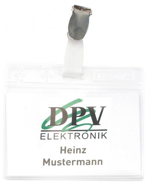 The image displays a name tag in a transparent cover. At the top, it reads "DPV ELEKTRONIK" in large letters, below which the name "Heinz Mustermann" appears in clear font. A clip fastener is attached at the top.