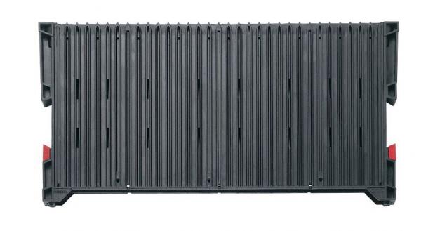 The image shows a rectangular, gray container with vertical grooves. There are red elements at the corners. The surface texture is uniform and sturdy.