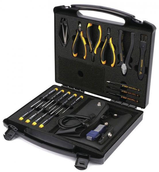 The image shows a toolbox with an open lid. Inside, various tools such as screwdrivers, pliers, and a cable are arranged in a padded, structured compartment.