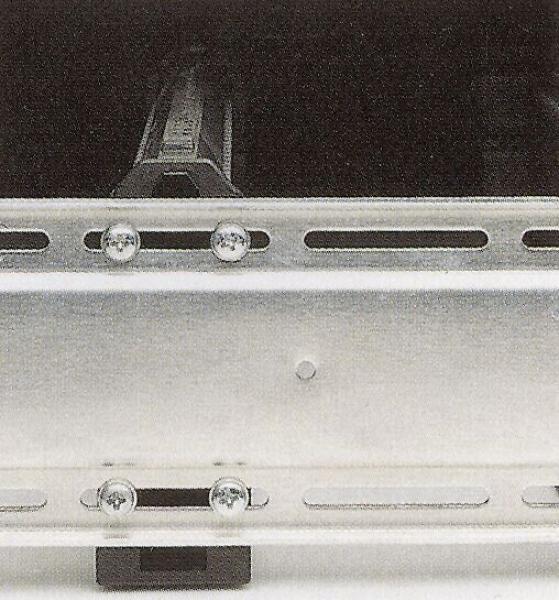 The image shows a silver metal structure with grooves and screws. This structure consists of two rails arranged parallel for fastening or guiding.
