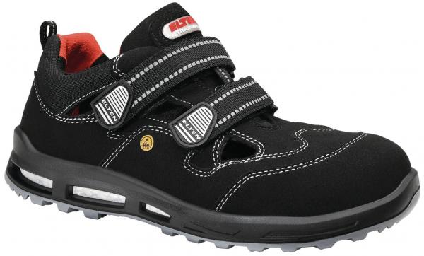 Der Schuh ist schwarz mit roten Akzenten und besteht aus einem strapazierfähigen Material. Er hat zwei breite Klettverschlüsse und eine rutschfeste Sohle mit Profil.