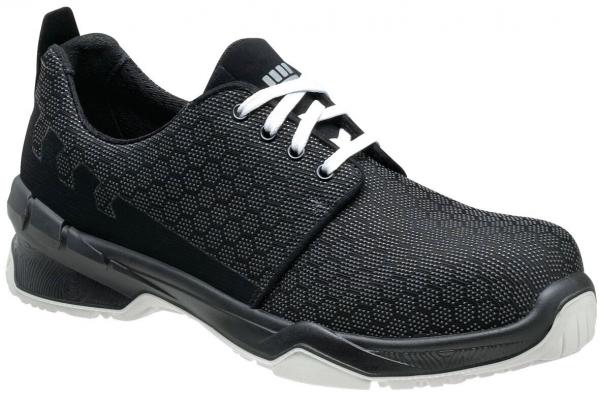 The shoe is black with a textured upper. It has white laces and a sporty, sturdy sole. The shape is modern and designed for comfort.