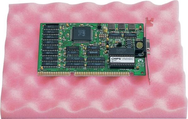 The image shows a green circuit board with various chips, connected wires, and slots, resting on a soft, pink surface. The board is rectangular and technology-related.