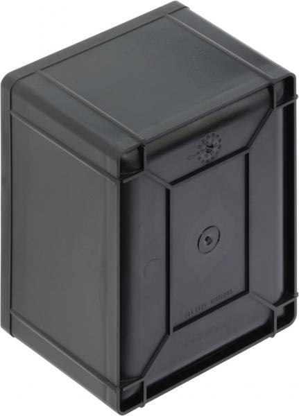The image shows a black, rectangular box with rounded corners. The surface is smooth, and on the front, there is a round slot or a hole for a key.