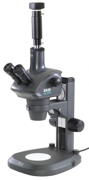 The image shows a black microscope with two eyepieces and a stable base. It has an adjustable foot and a round, bright surface for viewing samples.
