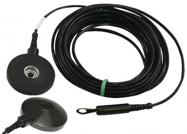 The image shows a black cable with a round end that has a small, flat, round surface. The other side has a plug. The cable is coiled and has a green marking.