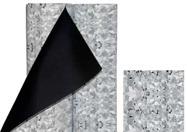 The image displays two rolls of fabric-like material. One roll has a silver, shiny surface with a coarse pattern, while a piece of black fabric is being stripped off.