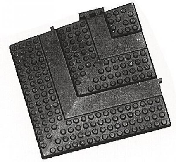 The image shows a rectangular grid pattern with raised dots and an L-shaped edge. It appears to be made of black material and is flat.