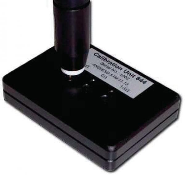 The image shows a black calibration device with a vertical, cylindrical column. On the surface, there is a label that reads "Calibration Unit 844".