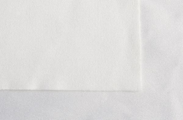 The image shows two white fabric surfaces. One has a smooth surface, the other is slightly textured. They are lying next to each other on a light background.