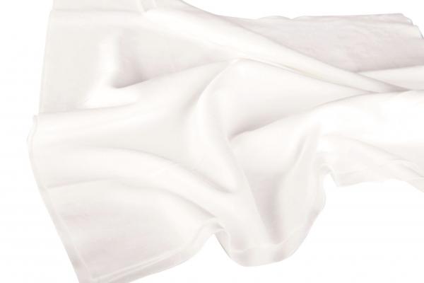 The image shows a white, slightly shiny fabric that is loosely and gently draped. The surface appears smooth and soft, and the folds give it a flowing movement.