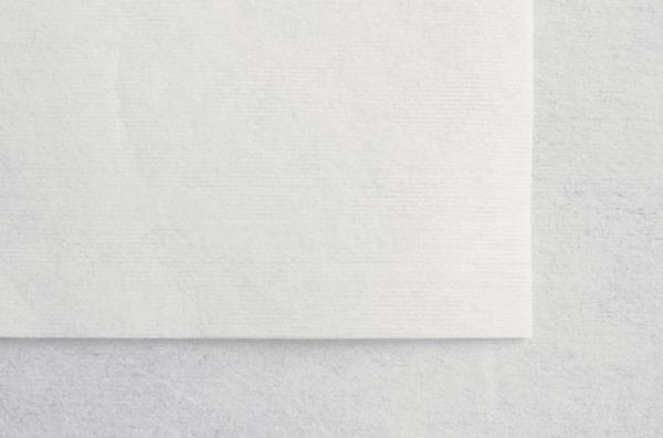 The image shows a simple, white sheet of paper lying on a light background. The texture of the paper is slightly textured.