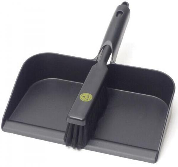 The image shows a black dustpan with an integrated broom. The pan has a wide, flat surface and the broom is attached to the side to facilitate sweeping.