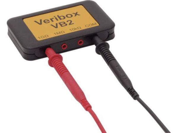 The image displays a compact, rectangular device with a yellow surface labeled "Veribox VB2". It features red and black inputs for electrical connections.