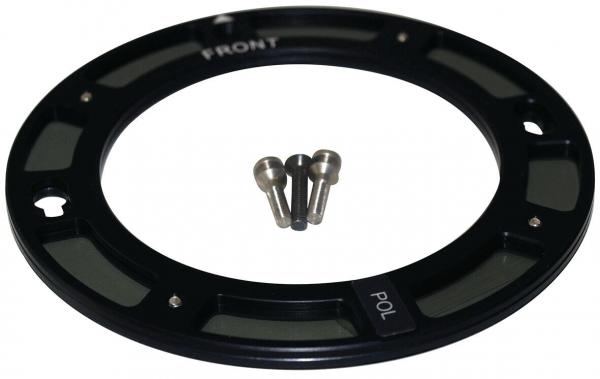The image shows a round, black metal ring with a narrow, green lens and two markings ("FRONT" and "POL"). It contains three small screws.