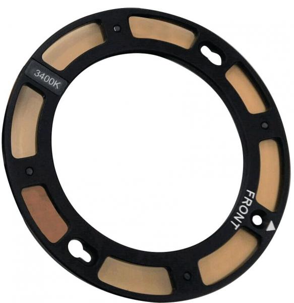 The image displays a circular black filter frame with several light brown filter segments. There are holes on the sides for attachment. The frame is marked with "FRONT" and "3400K".