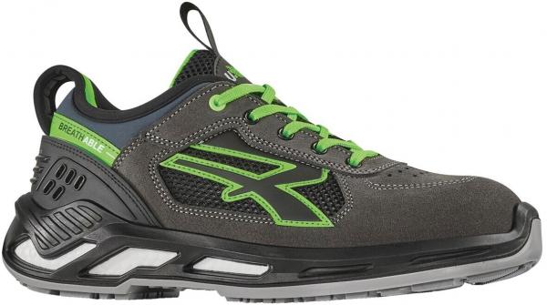 The shoe is a sporty sneaker in dark gray with green accents. It features a padded sole, a sturdy heel area, and laces for good support. Ideal for active use.