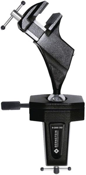 The image shows a black clamp with a fixed bracket and a movable clamp. It is used for securing workpieces during drilling or cutting.