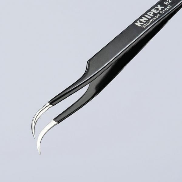 The image shows a sharp, metallic tweezer with two curved tips. It is painted black and has the inscription “KNIPEX” on one side.