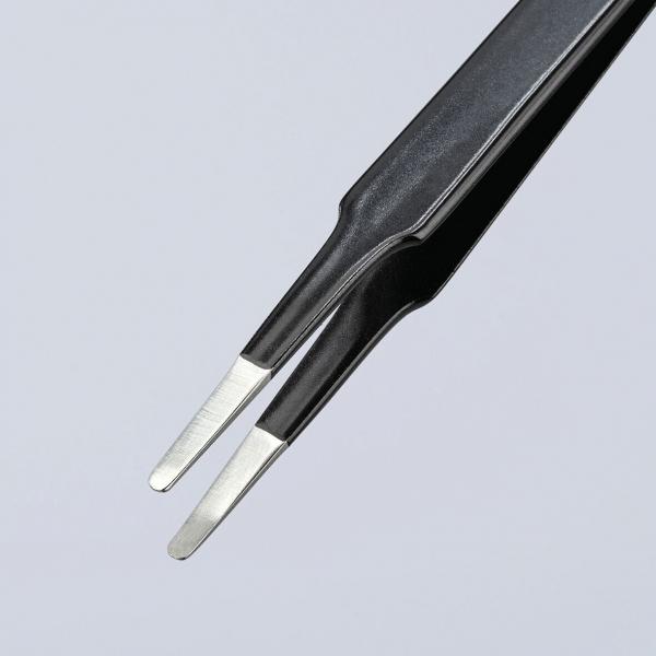 The image shows a black tweezer with flat, metallic tips. The tips are narrow and slightly curved, ideal for grasping small objects. The background is light and neutral.