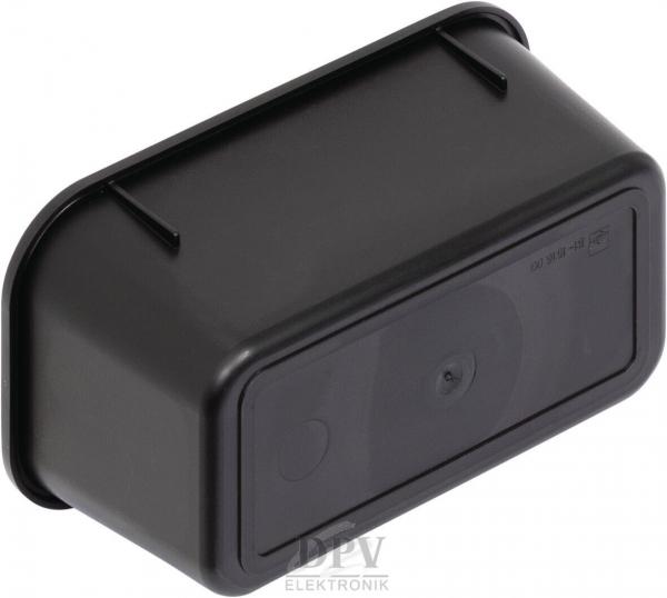 The image displays a black, rectangular object with rounded edges and a smooth surface. On the front, a small, round element is visible. It appears compact and sturdy.