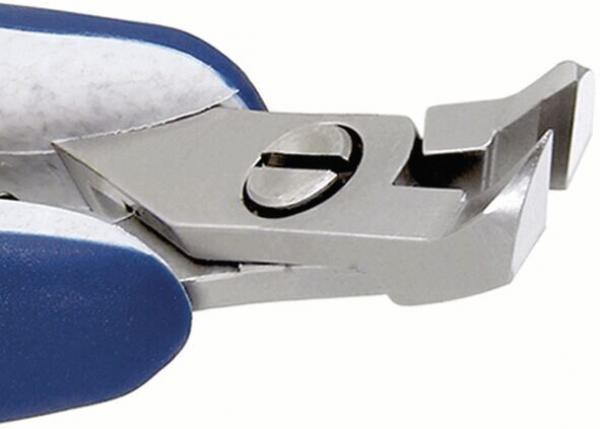 The image shows a metallic pair of pliers with blue handles. It has two gripping jaws that taper to a point. The top side is flat and features a round switch in the center.
