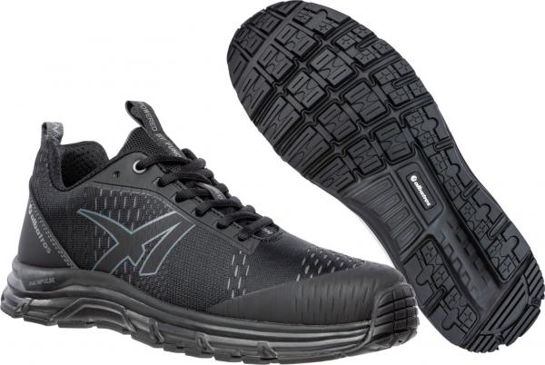 The image shows a black athletic shoe with a breathable upper. The sole features a textured pattern for good grip. The toe is slightly rounded and the shoe has a modern, sporty shape.