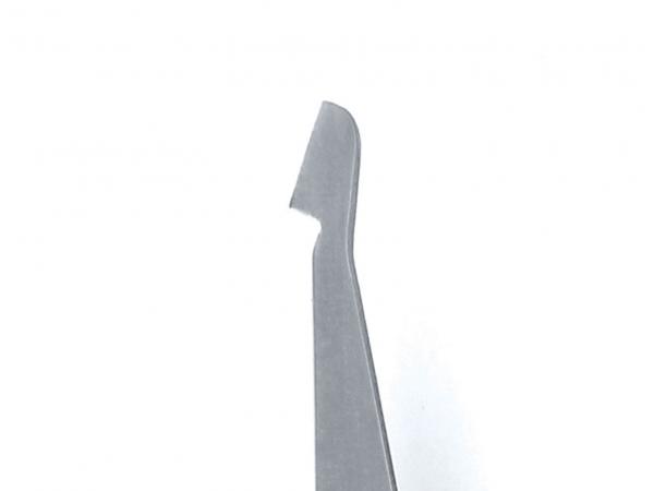 The image shows a narrow, silver blade tool with a sharp edge on one side. The shape is rectangular and industrial.