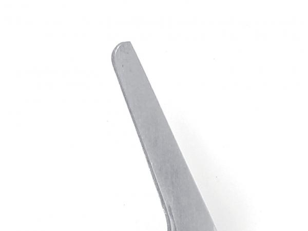 The image shows a narrow, long metal object with a flat, straight edge and a rounded tip. The surface is smooth and silver-colored.