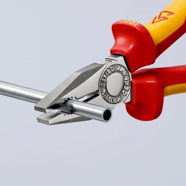 The image shows a pair of pliers with red and yellow handles gripping a thin metal rod. The pliers have a silver, metallic surface with a serrated edge.