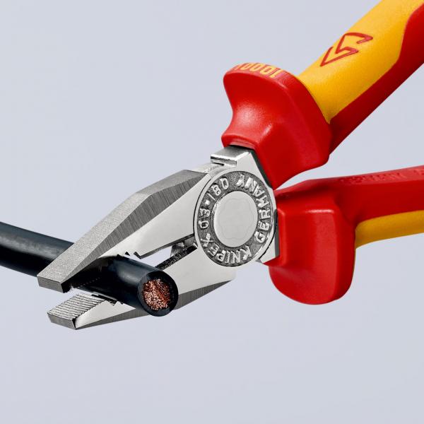 The image shows a pair of pliers with red and yellow handles holding a black wire. The edges of the pliers are metallic and sharp, and the wire reveals a copper inner structure.
