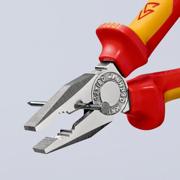 The image shows a pair of pliers with red-yellow plastic handles. The tip of the pliers is flat and has a grooved surface. A metal pin is placed between the jaws.