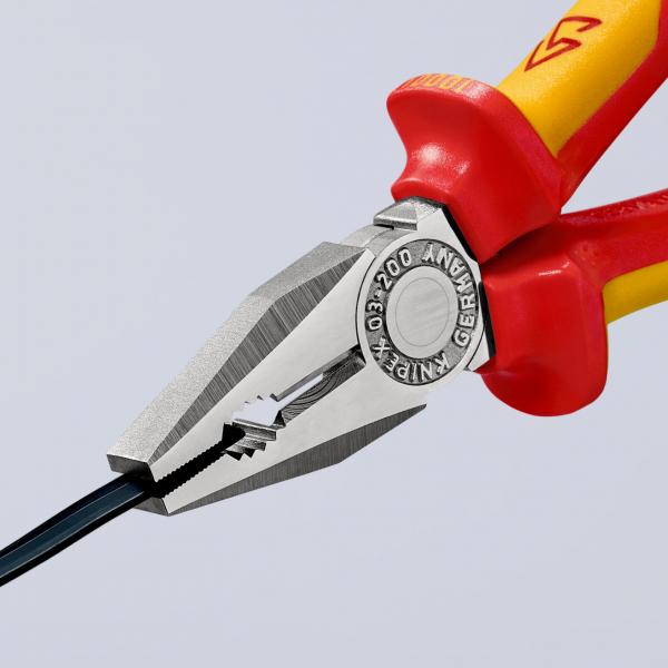 The image shows a pair of pliers with red handles and a silver working surface. The pliers have pointed and flat edges and are holding a black wire. They are precisely crafted.