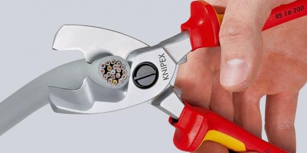The image shows a hand holding a pair of pliers. The pliers have red and yellow handles and a shiny, silver tip with a circular opening area, ideal for cutting wires.