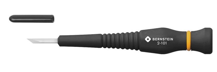 The image shows a black screwdriver with a round handle and a narrow, flat blade. Next to it is a small, black cap attachment. The handle has a yellow stripe.
