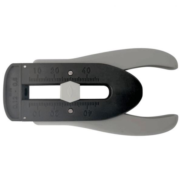 The image shows a tool with two gray handles and a black body. It has a scale with numbers from 0 to 70 mm and a central opening. It is used for measuring or punching.