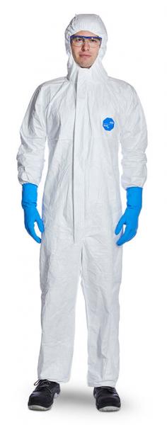 In the picture, there is a person in a white hooded protective suit. They are wearing blue gloves and safety goggles. The person appears professional and protected.