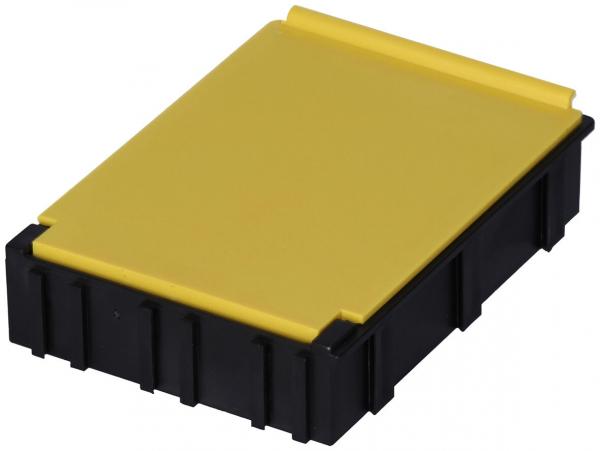 The image displays a rectangular container with a yellow top and a black bottom. It has a smooth, solid surface and a textured underside with vertical grooves.