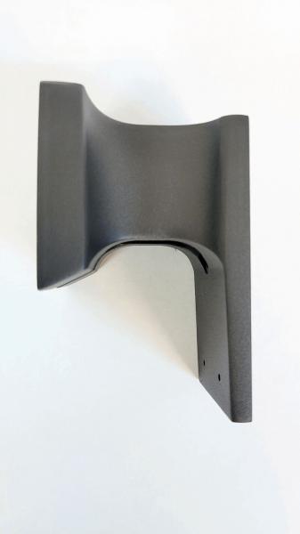 The image shows a black bracket with curved edges. The back is flat and features two holes for mounting. It appears sturdy and has a matte finish.
