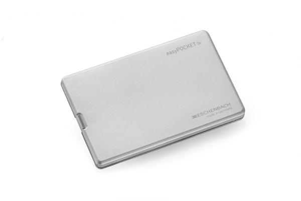 The image shows a flat, rectangular, silver metal box that looks like a business card holder. It has rounded corners and a smooth surface with a slight reflection.