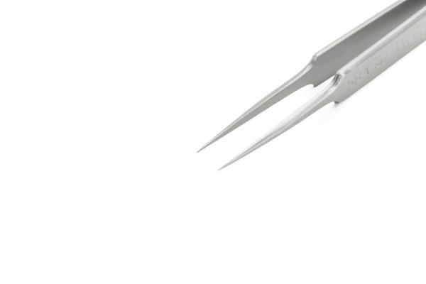 The image shows a slim, metallic tweezer with pointed ends. It is lying on a bright, solid-colored background and appears sharp and precise.