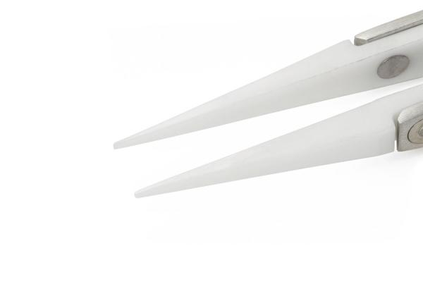 The image shows the tips of a pair of scissors. They are narrow and sharp, made from shiny metal, with a silver hinge in the center. The background is solid white.