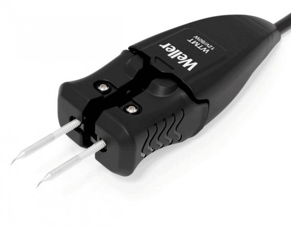 The image shows a black electric plug with two metal pins. The plug has a serrated surface for better grip and a cable that extends from it.