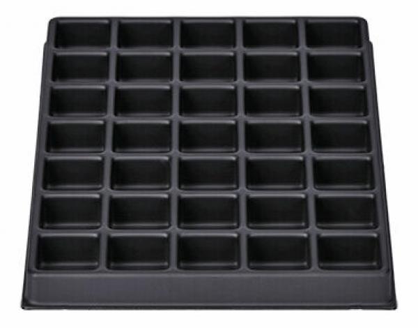 Das Bild zeigt eine rechteckige, schwarze Backform mit 36 gleichmäßig verteilten, kleinen Vertiefungen, die für Muffins oder Cupcakes geeignet ist. Die Oberfläche ist glatt.