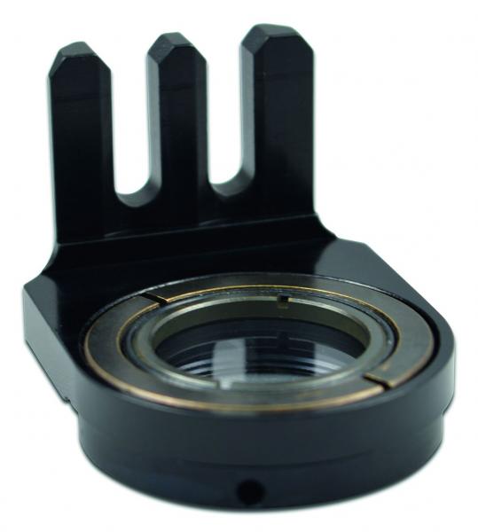 The image shows a black, metallic component with a round opening and three protruding elements. It has a smooth surface and is designed for mechanical connections.