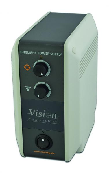 The image shows a rectangular, gray device with a dark front. It features two round dials and a power switch at the bottom. On the front, it reads "Vision Engineering" and "Ringlight Power Supply".