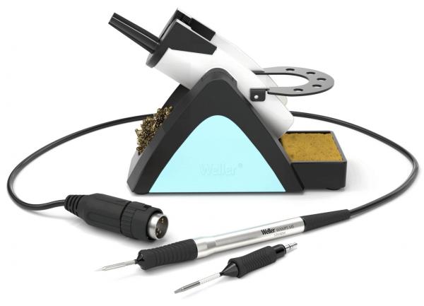 The image shows a soldering iron with a stand. The stand has a blue area and contains sponge material. Next to the soldering iron are two soldering iron tips and a cable.
